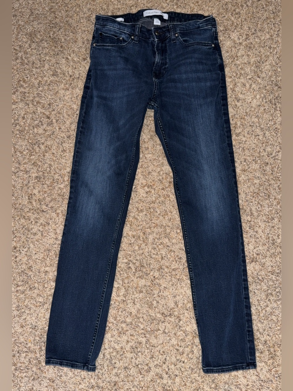 Calvin Klein men’s skinny-fit jeans in a dark blue wash. Size W30 x L30.